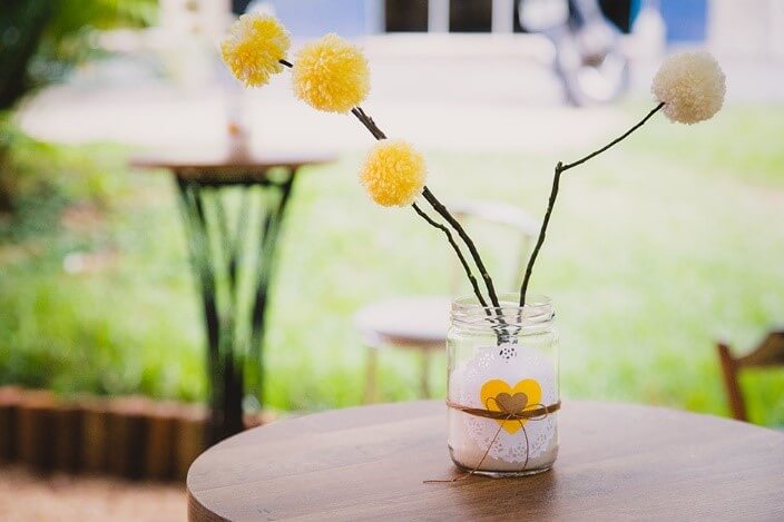 Outros potinhos de vidro também podem ser enfeitar a mesa. Tereza Pires usou pompons (crédito da foto: Mariana Leal Fotografia)