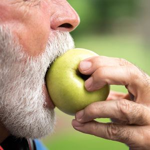 man biting an apple