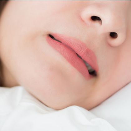 A woman grimacing in pain