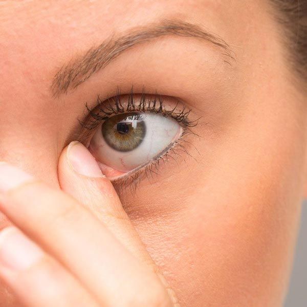 Closeup of woman rubbing eye