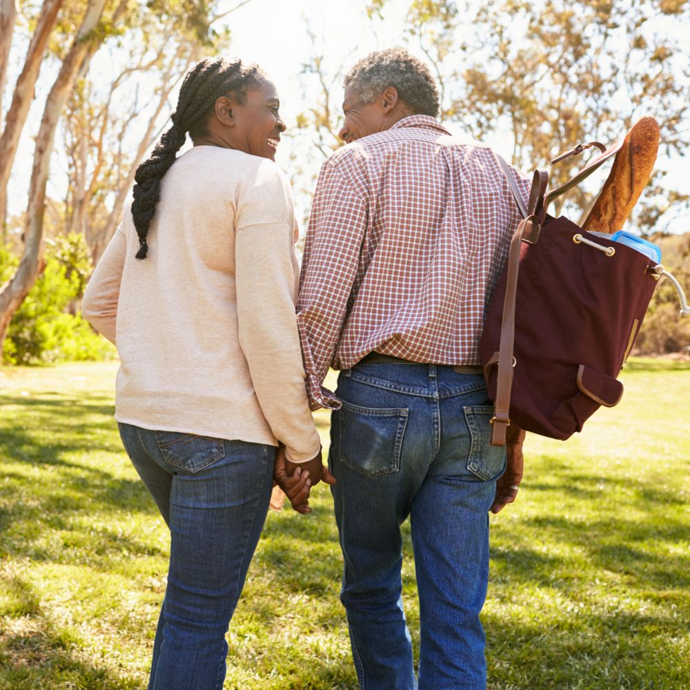 happy couple with healthy lungs holding hands while walking in the park