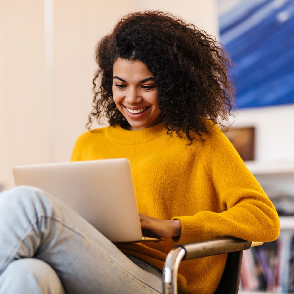 Smiling woman using laptop