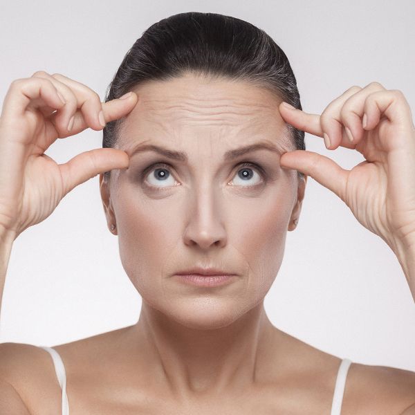 A woman wrinkling her forehead