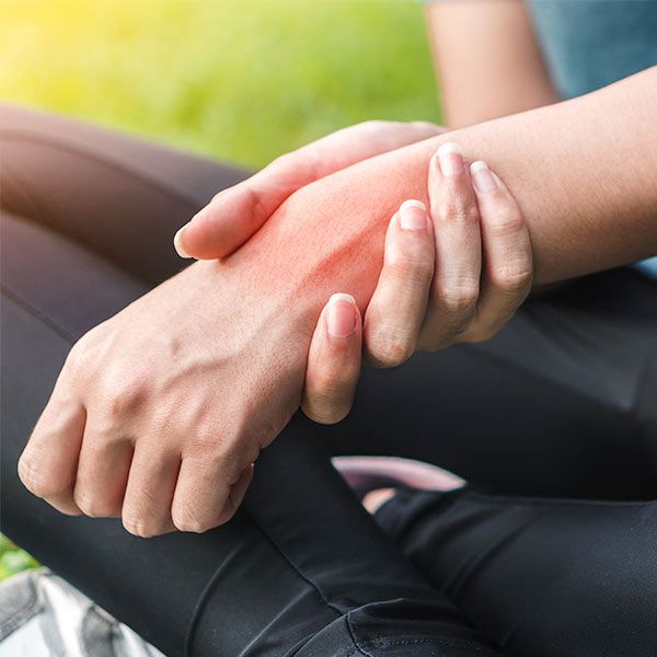 Woman holding inflamed wrist