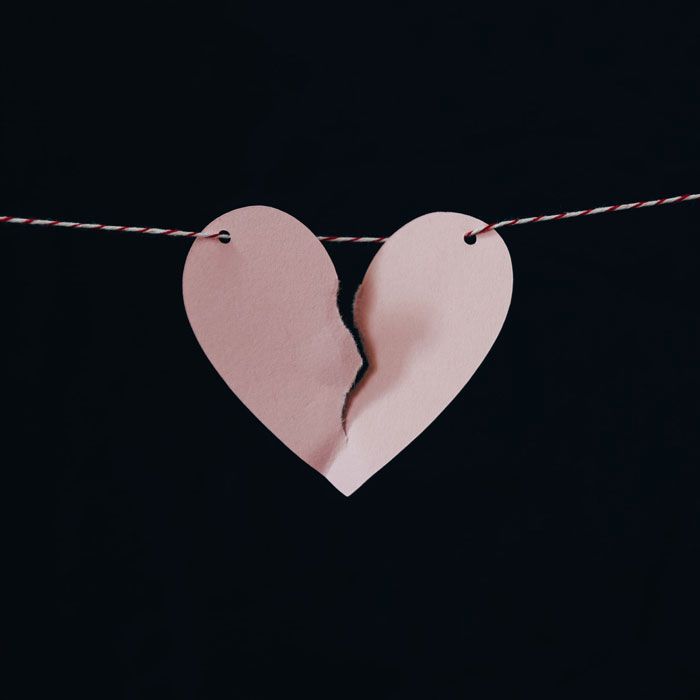 Torn paper heart on string