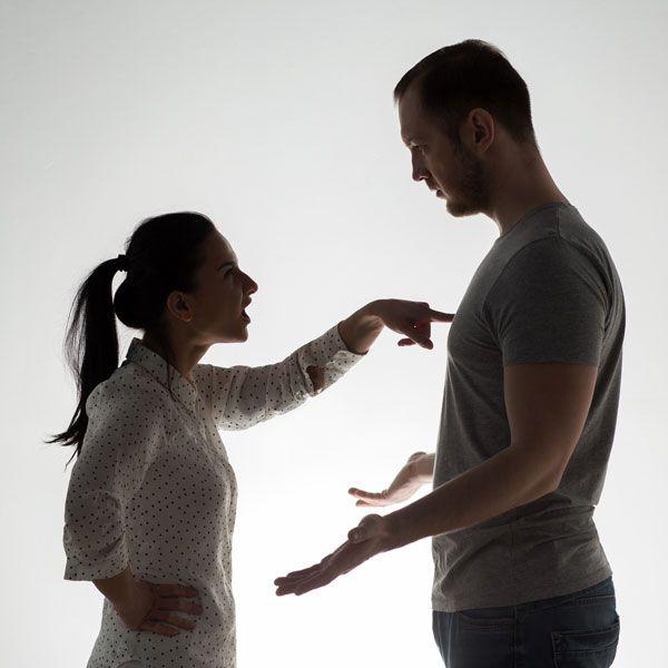 Woman aggressively poking man's chest