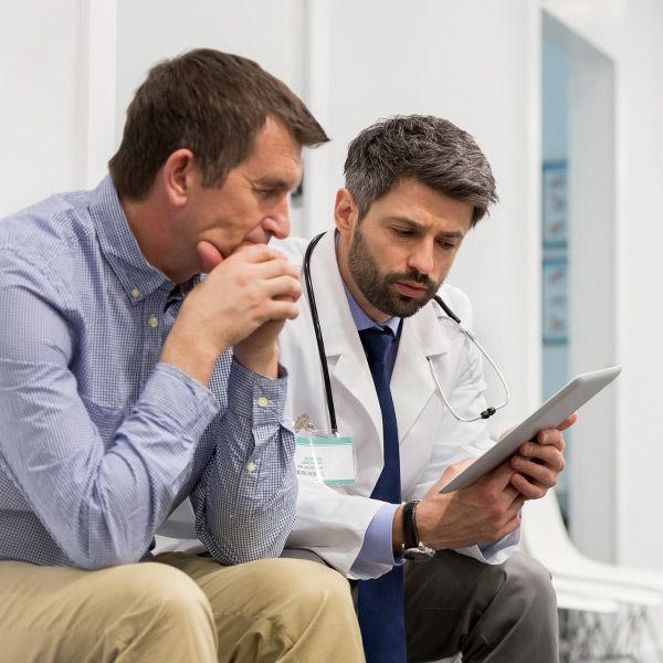 Man sitting with doctor