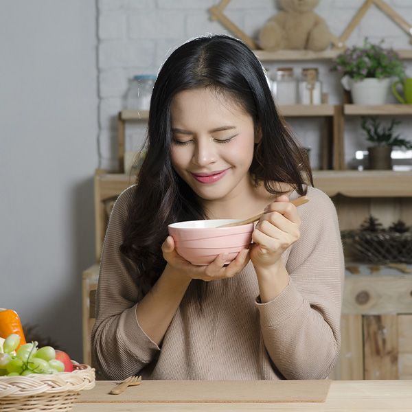 A woman eating out of a bowl