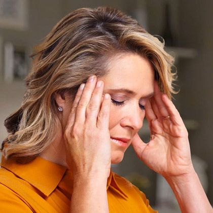 Woman rubbing temples