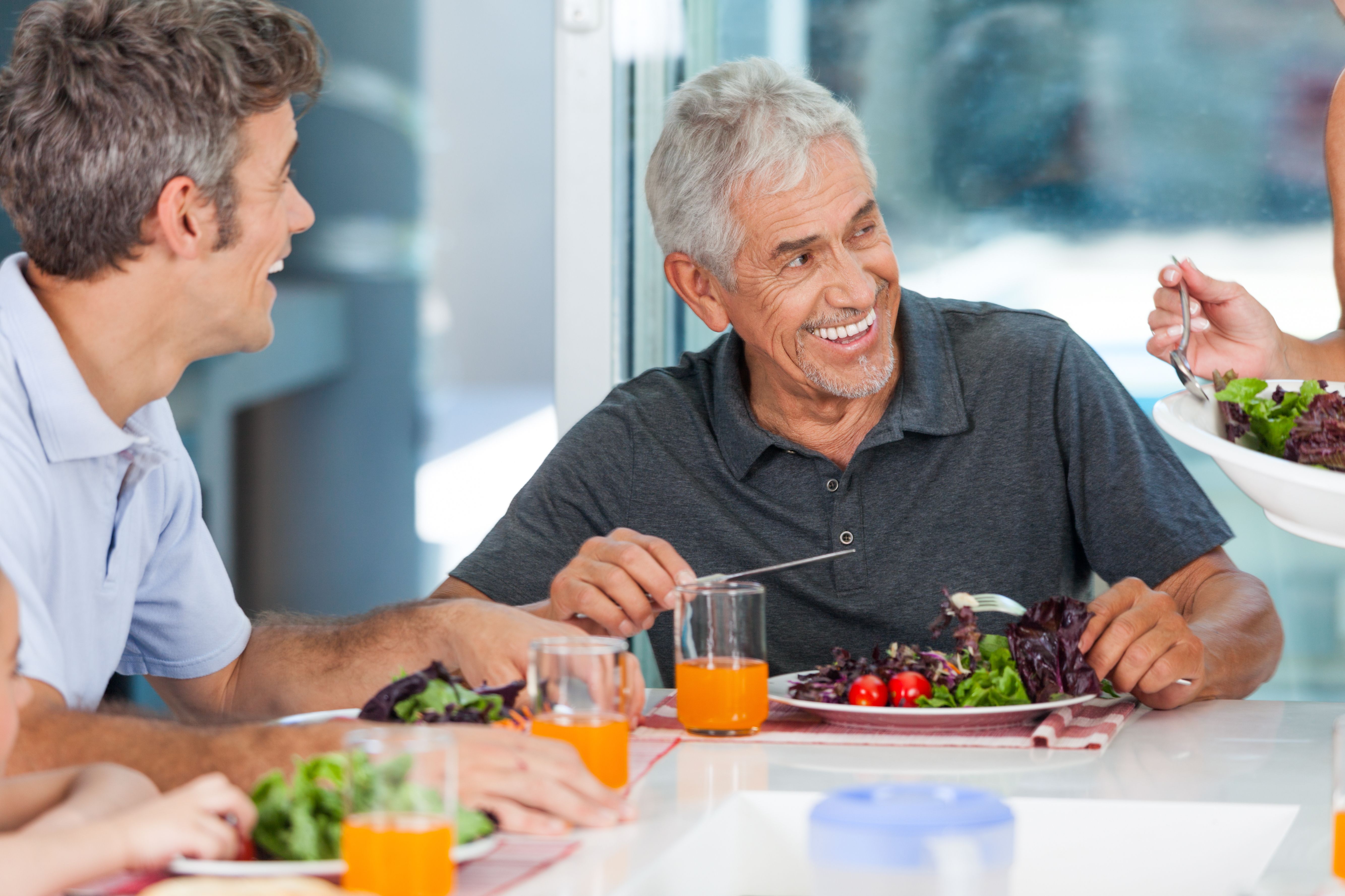 Senior man laughing with family