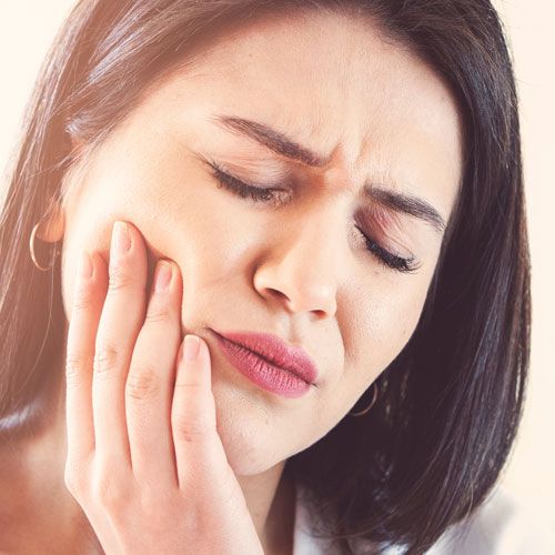 Woman holding jaw