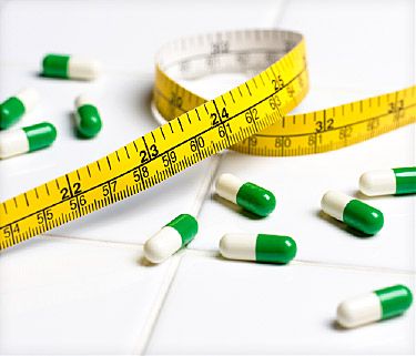 Measuring tape and weight loss pills