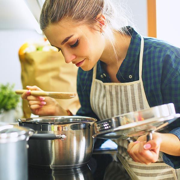 Woman smelling sauce