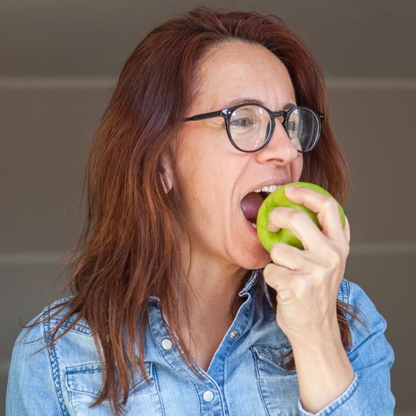 Woman biting into apple