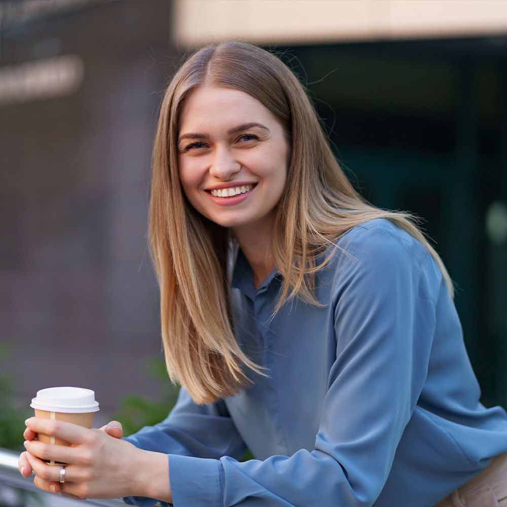 Smiling woman holding drink
