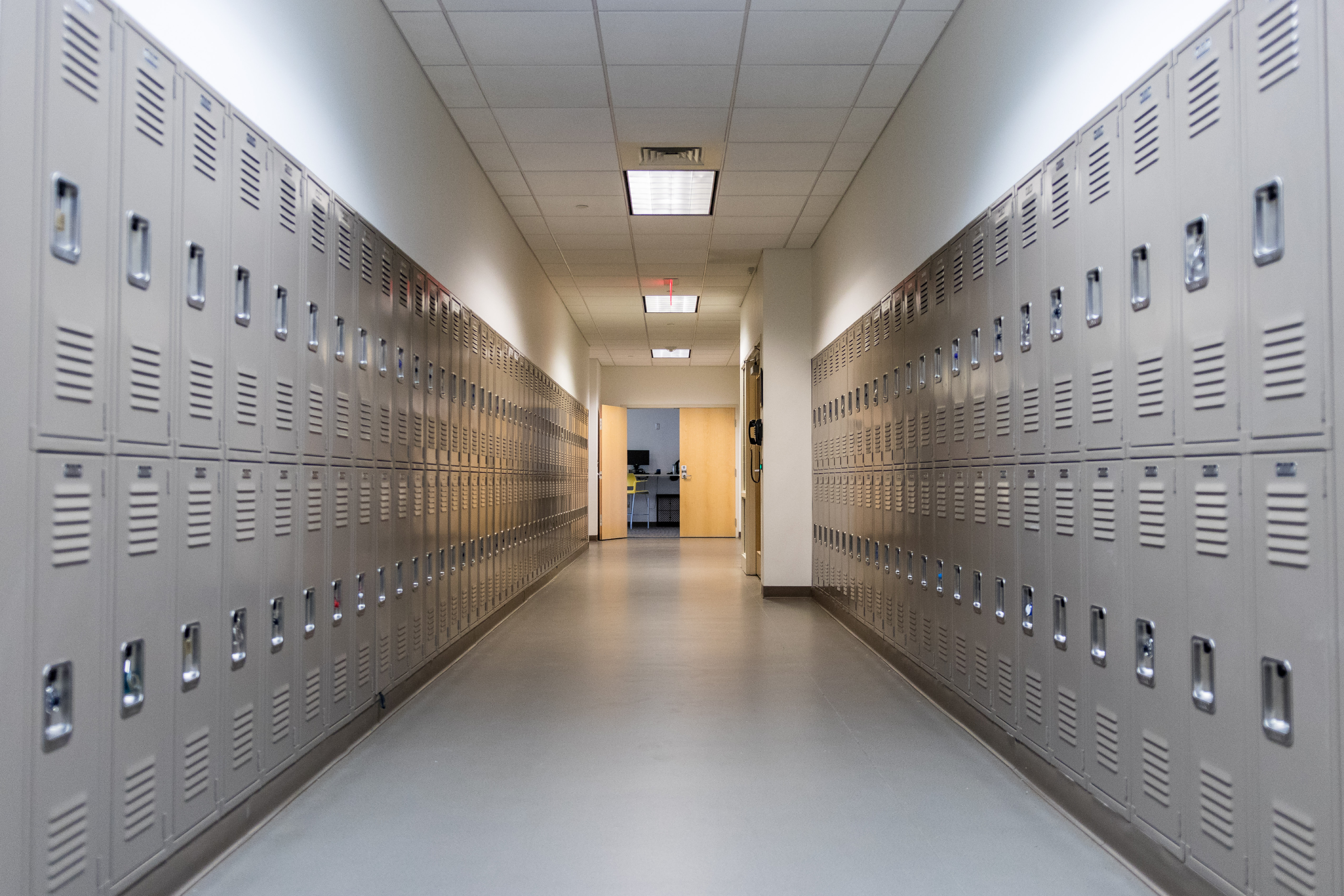 Looking down two rows of lockers in the hallway of a school