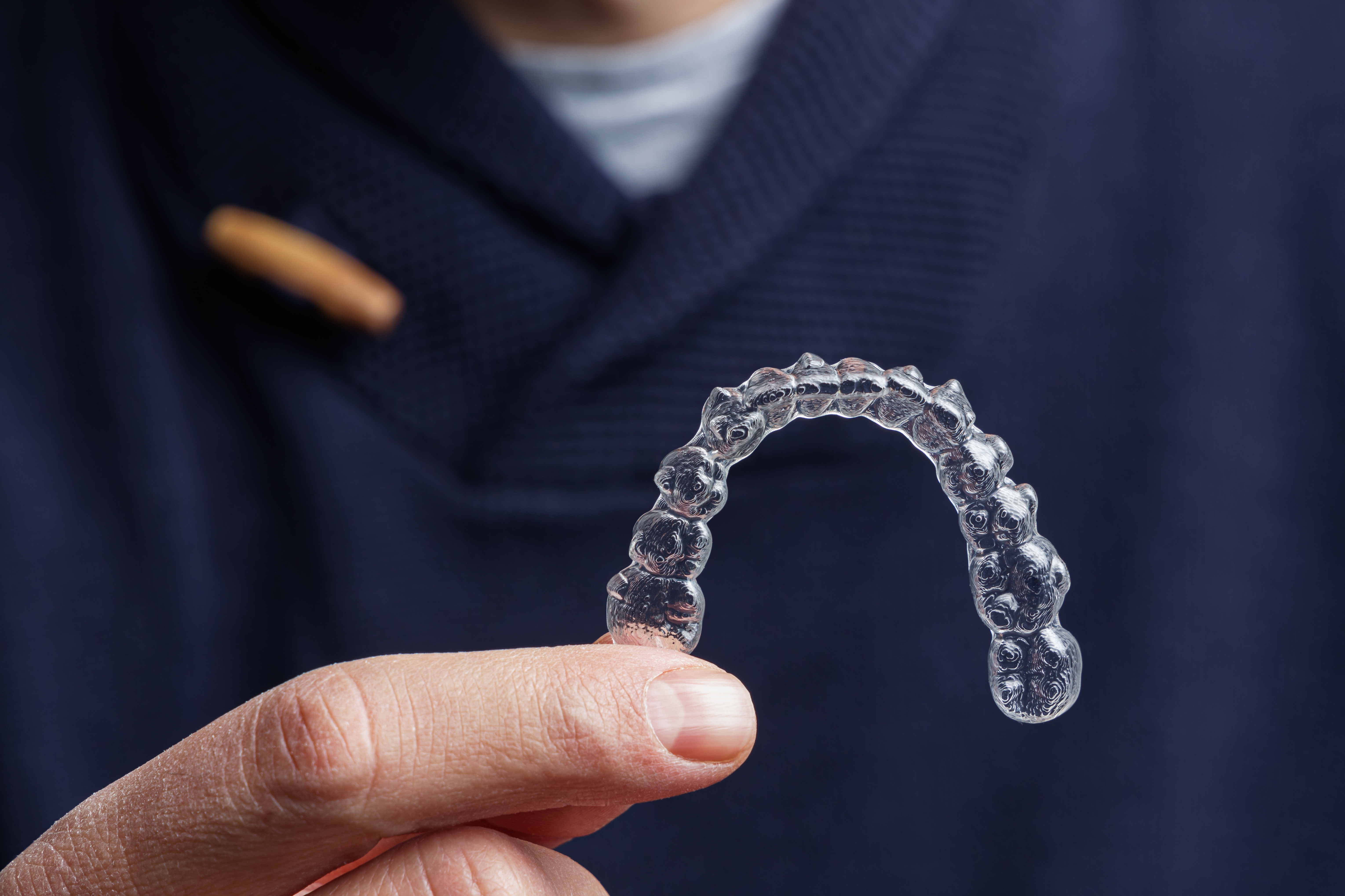 Man holding Invisalign tray