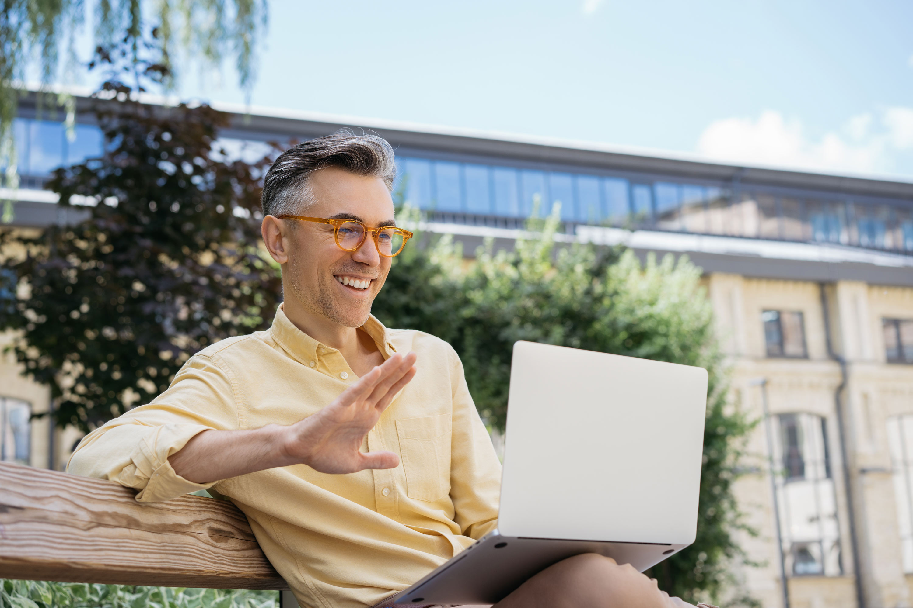 Smiling man with dental implants on a video call
