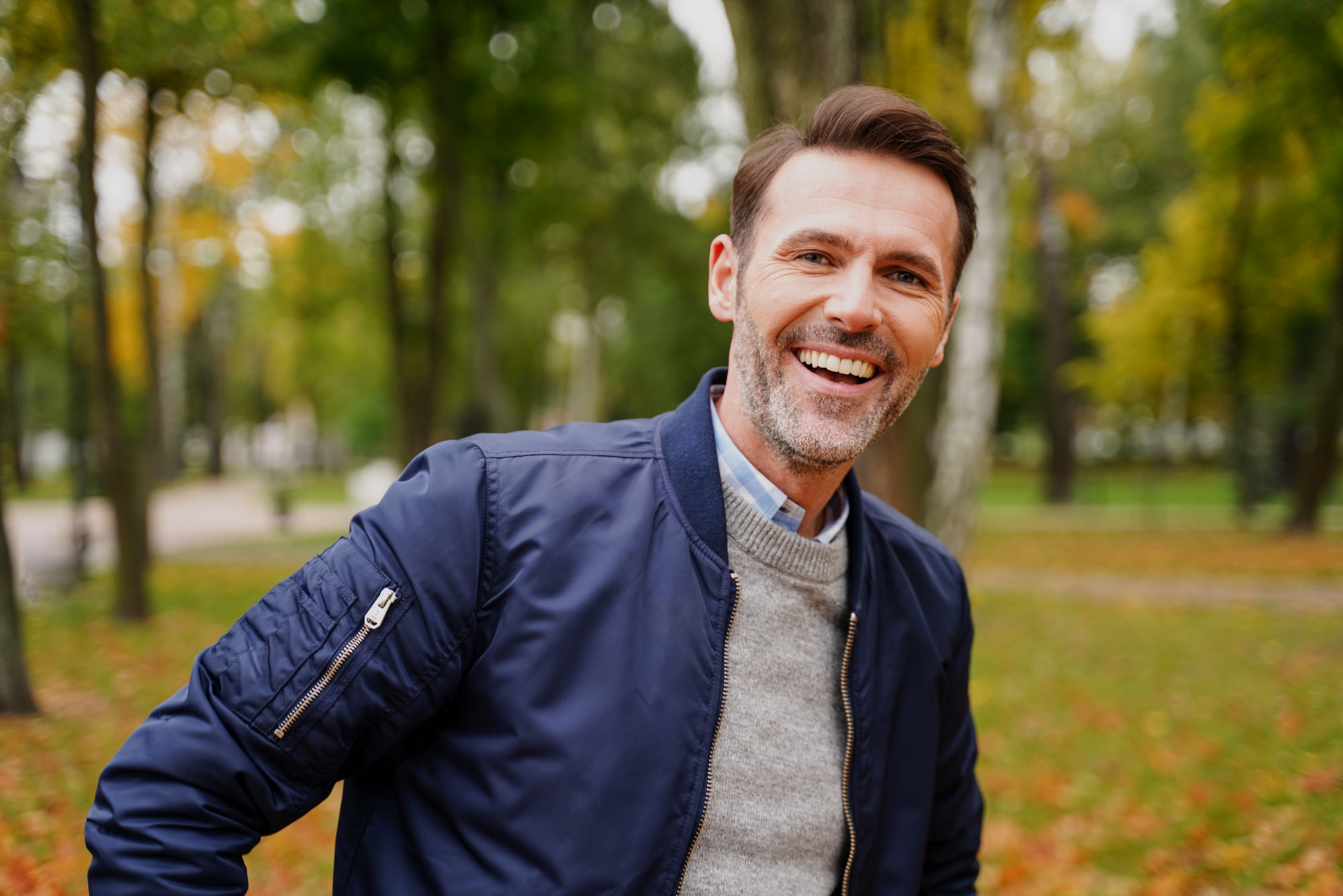 Smiling man after hair restoration surgery