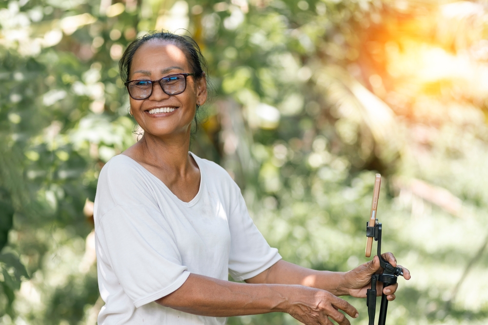 Older woman with a selfie-stick outdoors