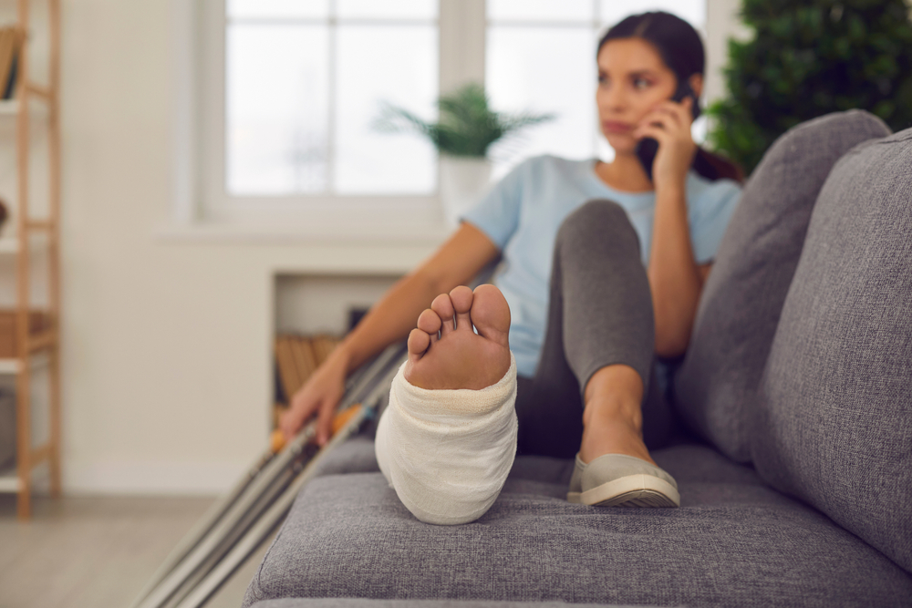 Woman on her couch recovering from a leg injury