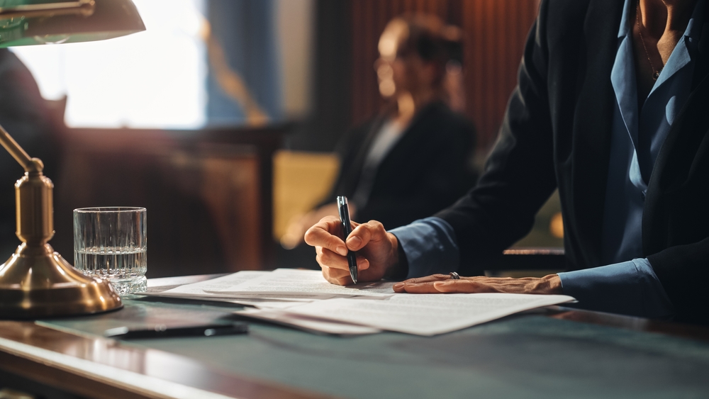 Lawyer taking notes while in a courtroom