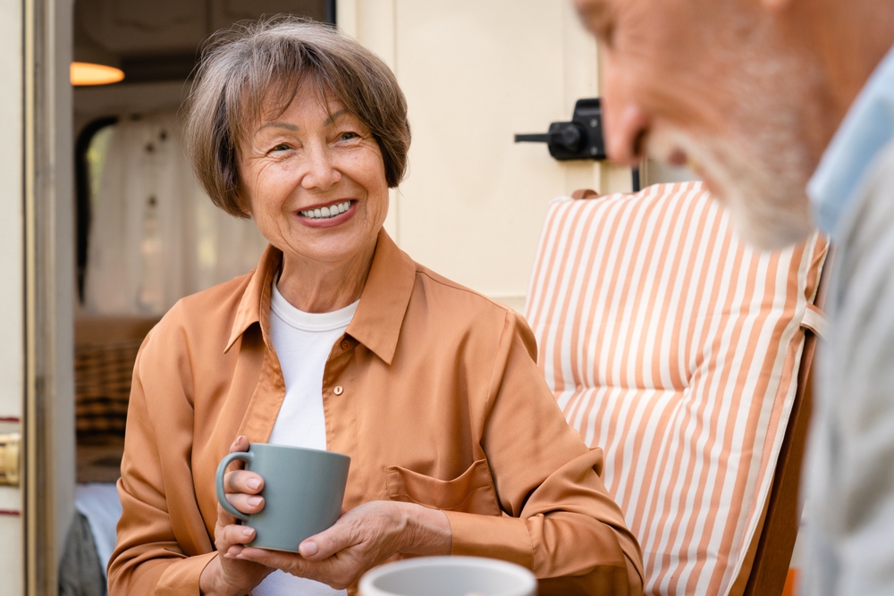 Elderly couple enjoying coffee outside together