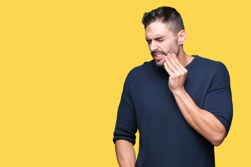 Man with a sore tooth and jaw