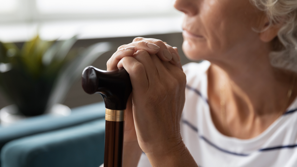 Elderly woman looking out the window