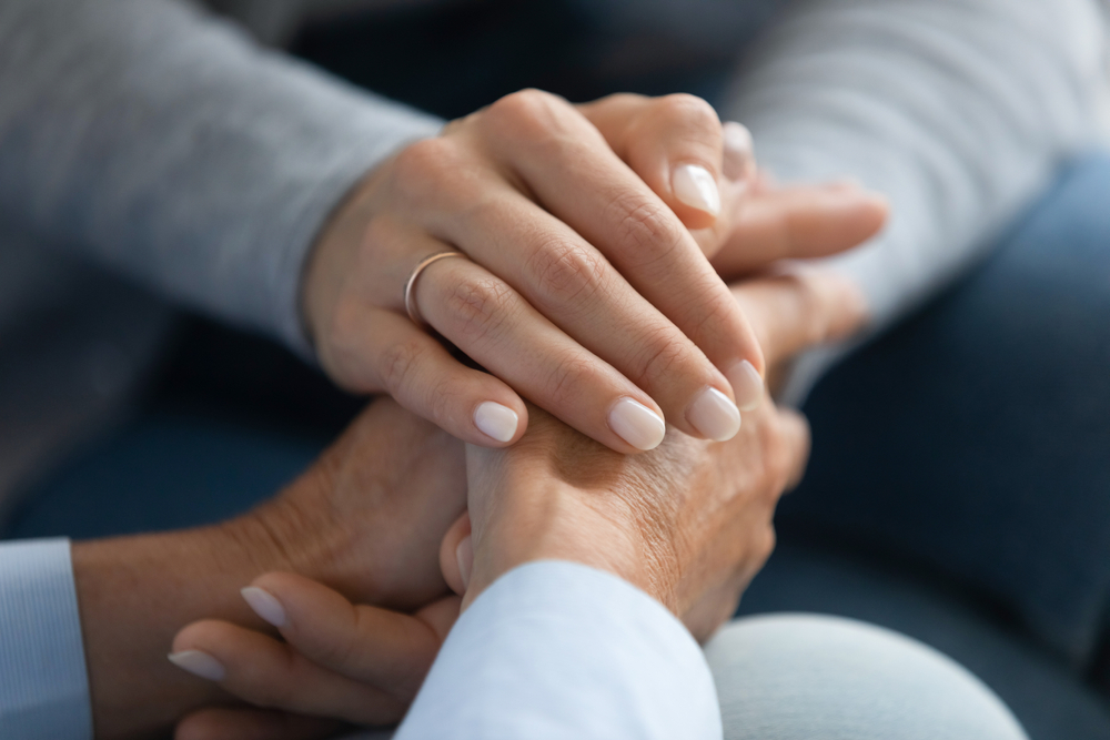 Family member holding an elderly loved one