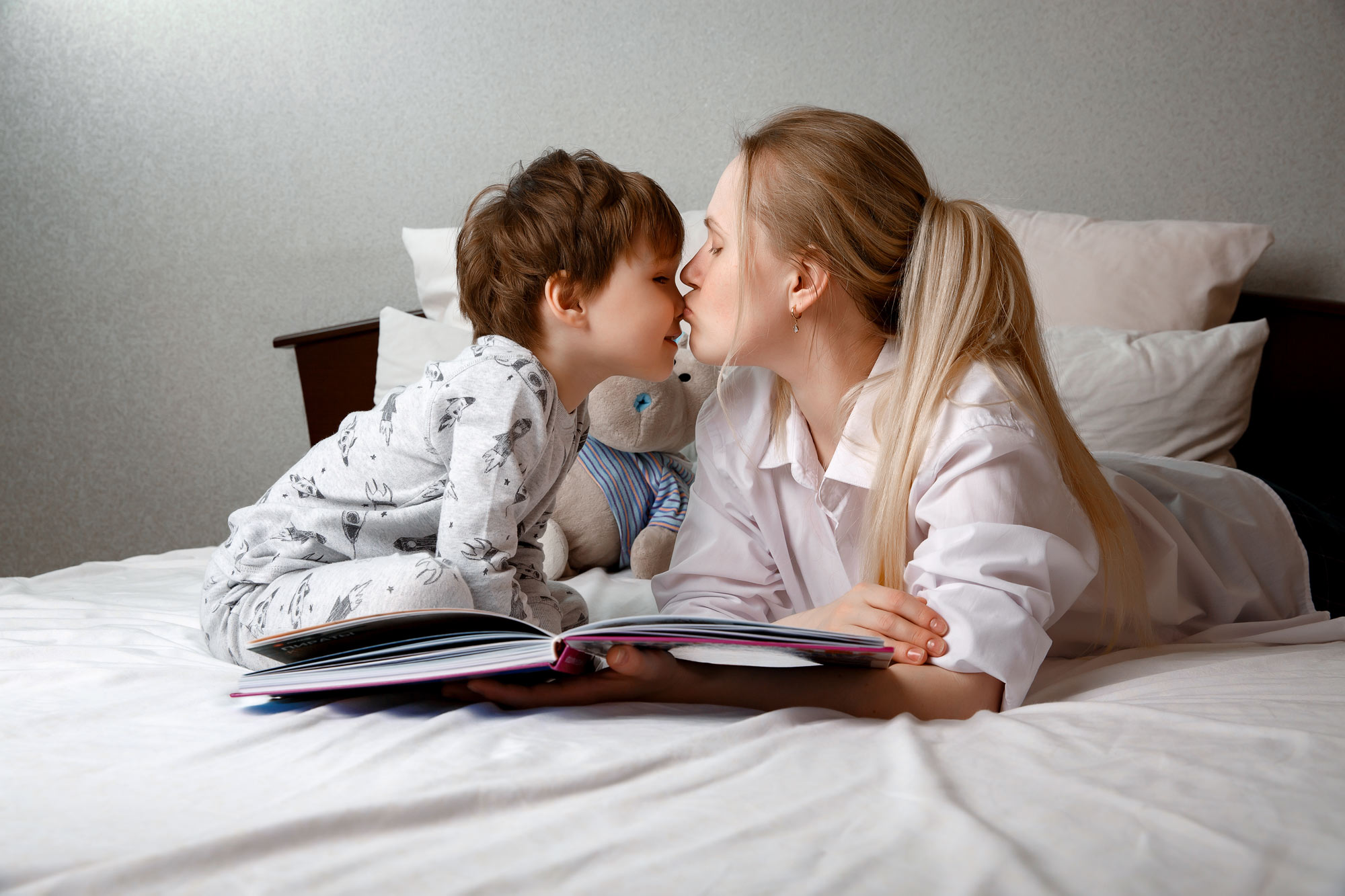 Mother reading with young boy after his microtia treatment