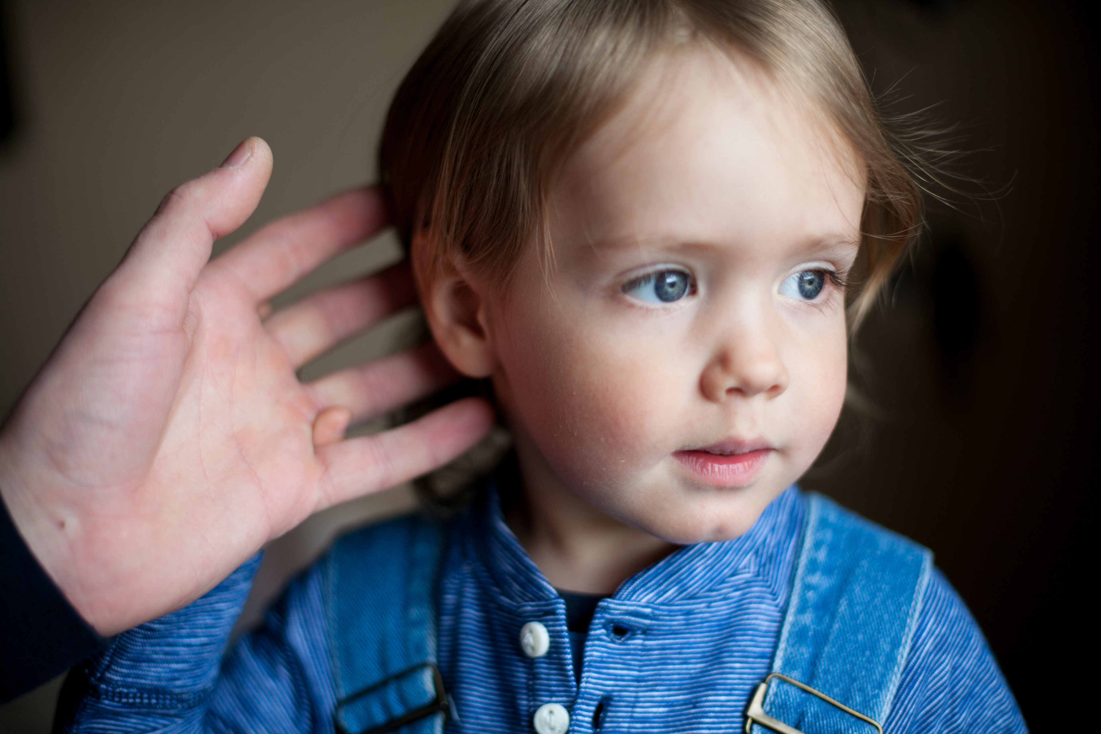 Adult cupping toddler