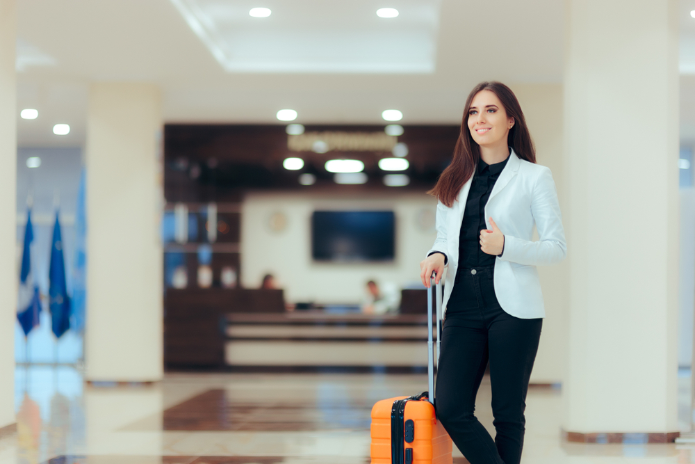 Guest in a hotel lobby with her luggage