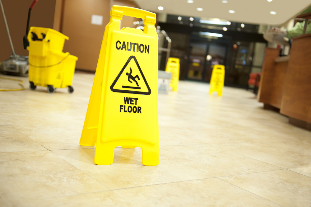 Wet floor with signs in a hotel lobby