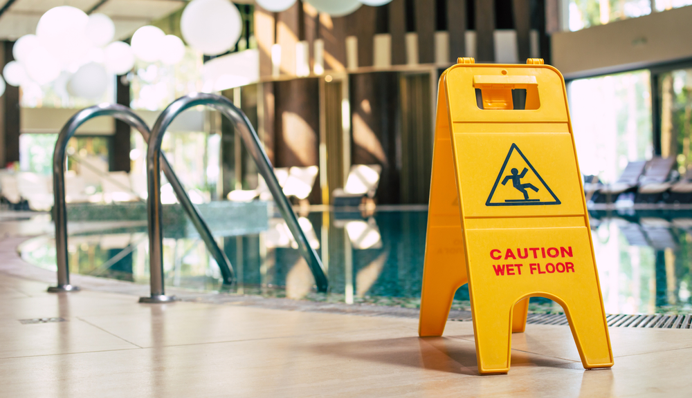 Wet floor sign by a hotel indoor swimming pool