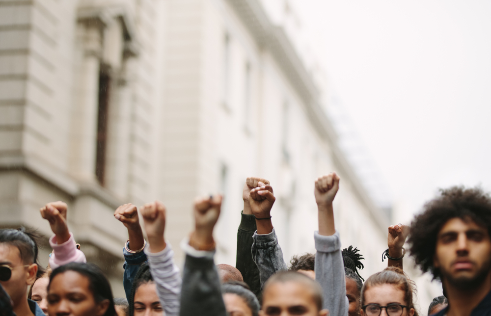 Protesting workers raising their fists in solidarity while on strike