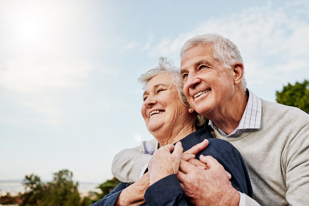Smiling elderly couple together outdoors