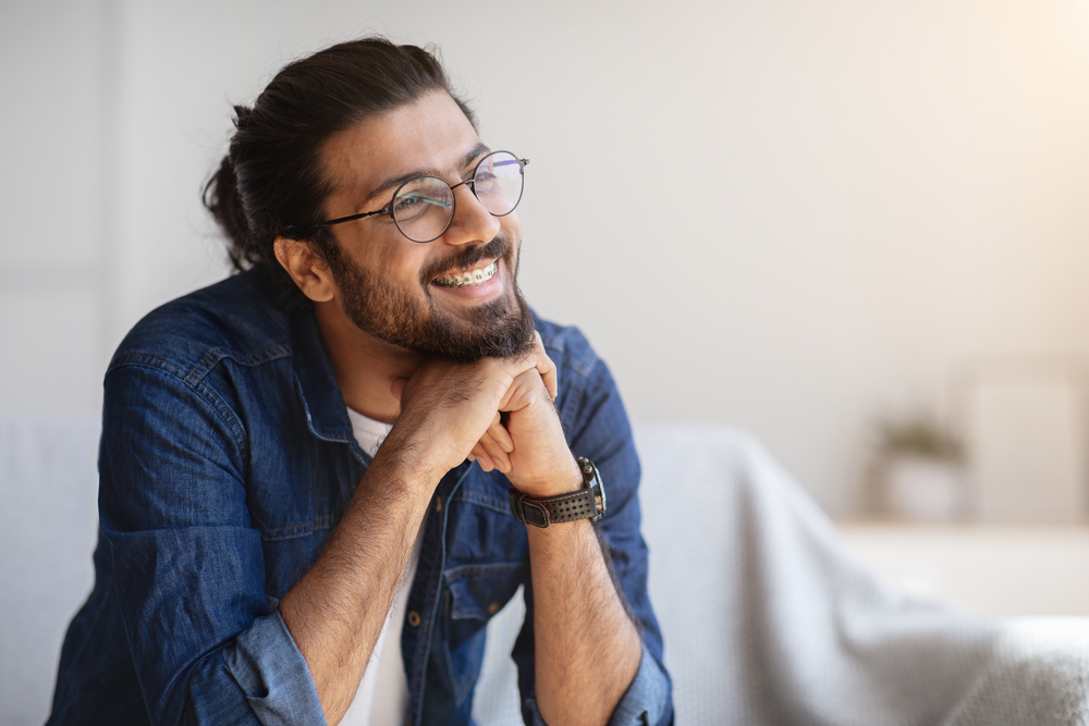 Young man with adult braces smiling