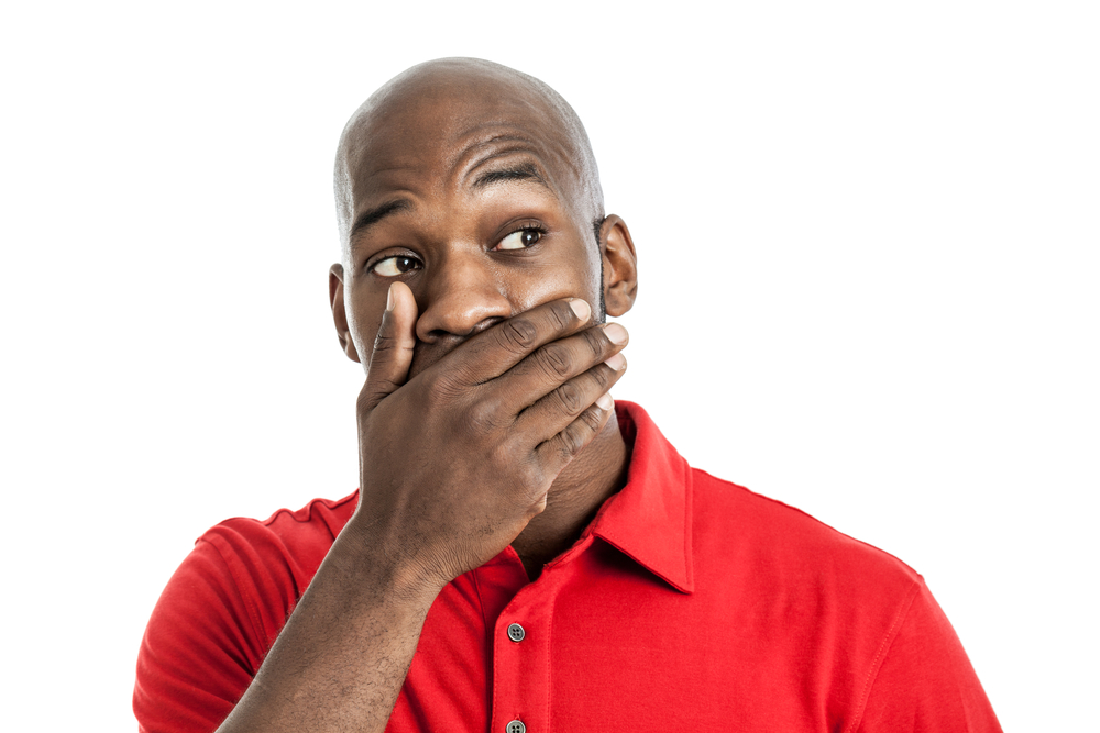 Man covering mouth in shock