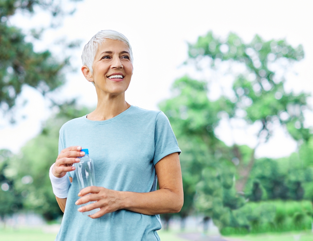 Athletic older woman smiling after a run