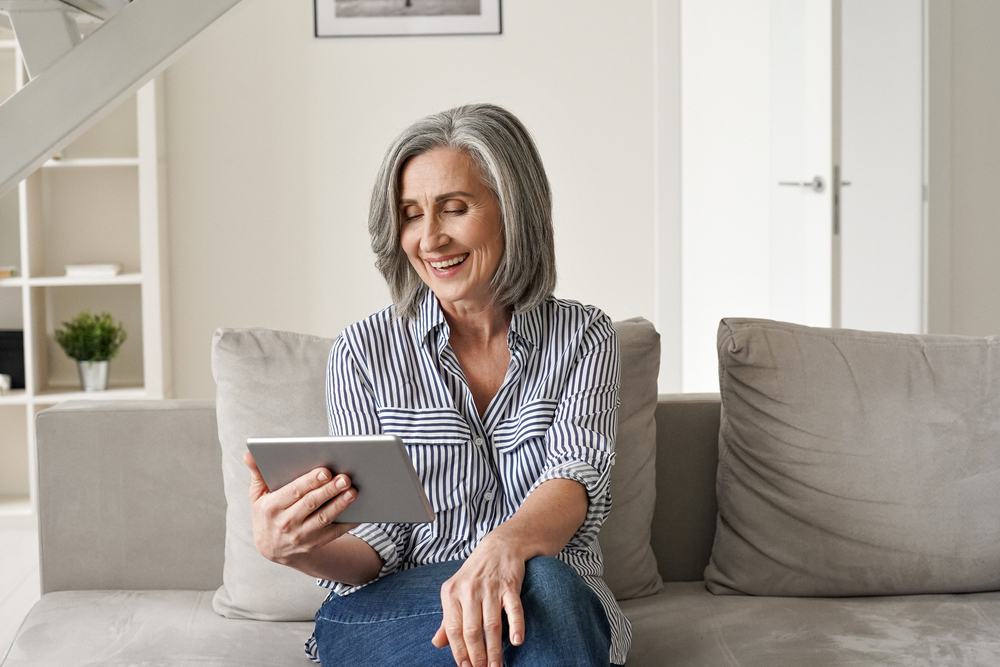 Woman watching a video on her tablet in her living room