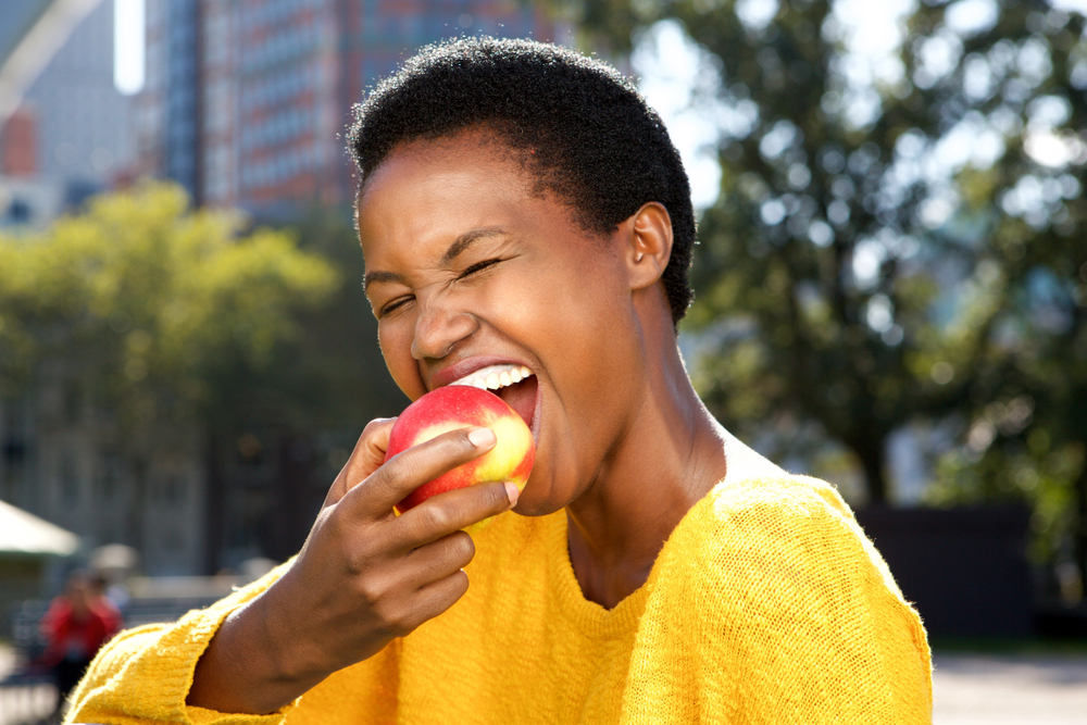 Woman biting into a nectarine