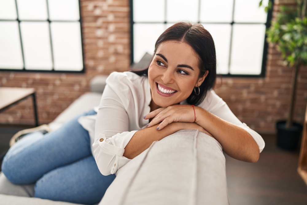 Smiling young woman in her living room