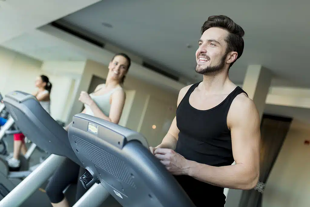 Man and woman exercising on treadmills