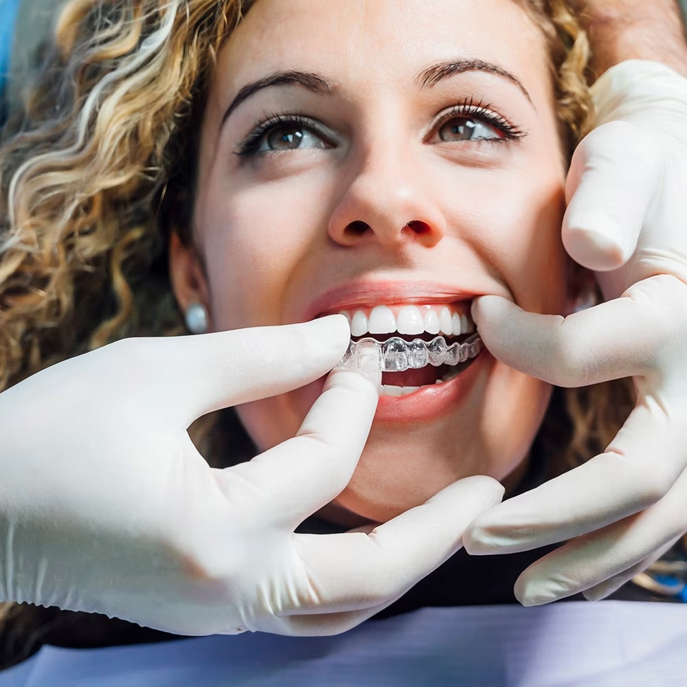 Smiling Invisalign patient during an exam