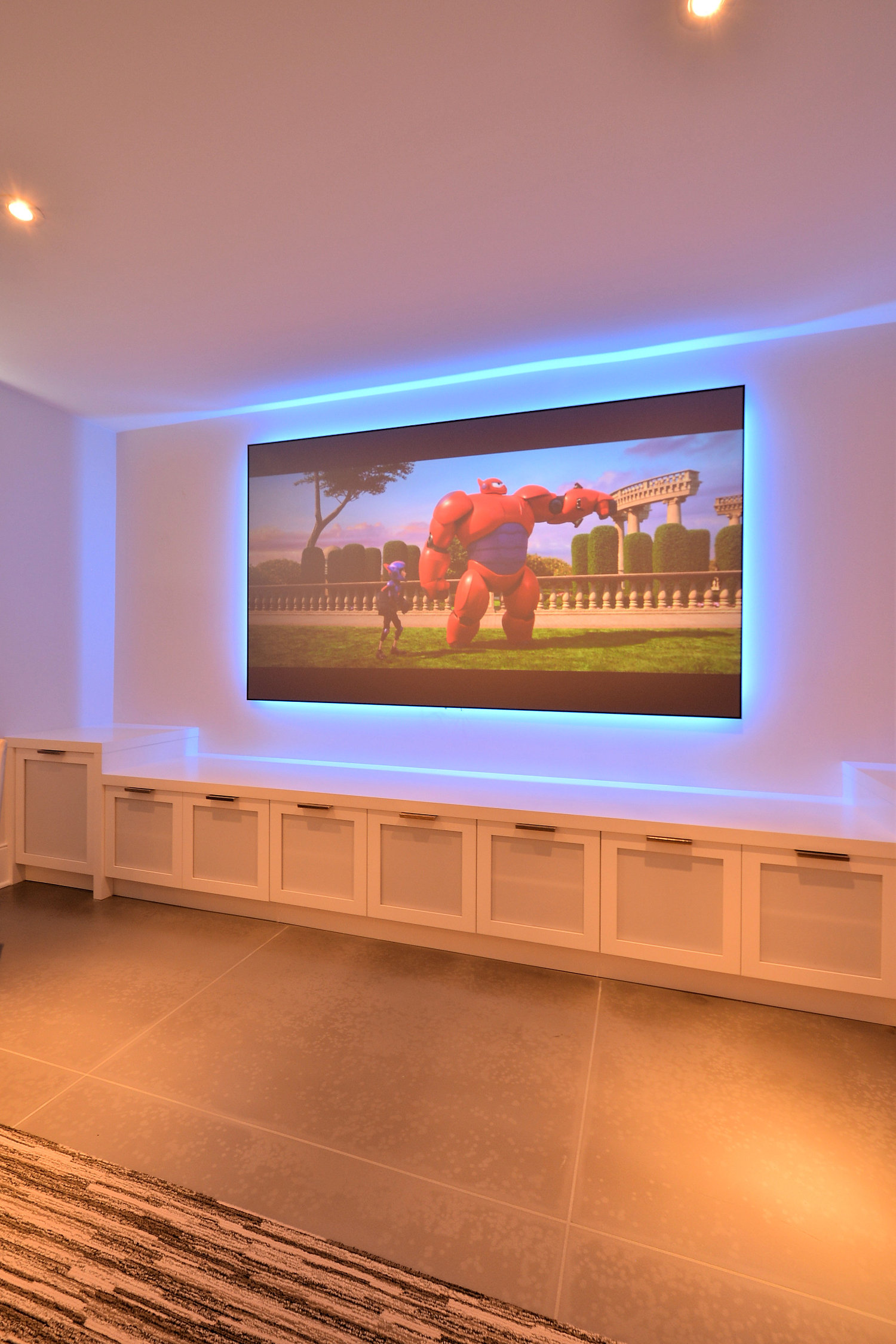 Blue LED lighting frames the flatpanel TV and adds dimension.