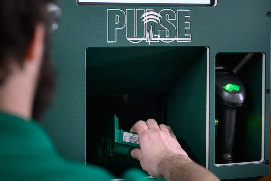 step 2) person placing empty bins in PULSE kiosk 