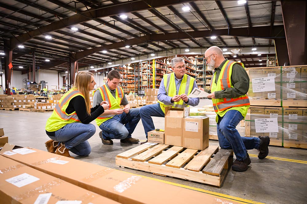Endries team members reviewing parts in warehouse