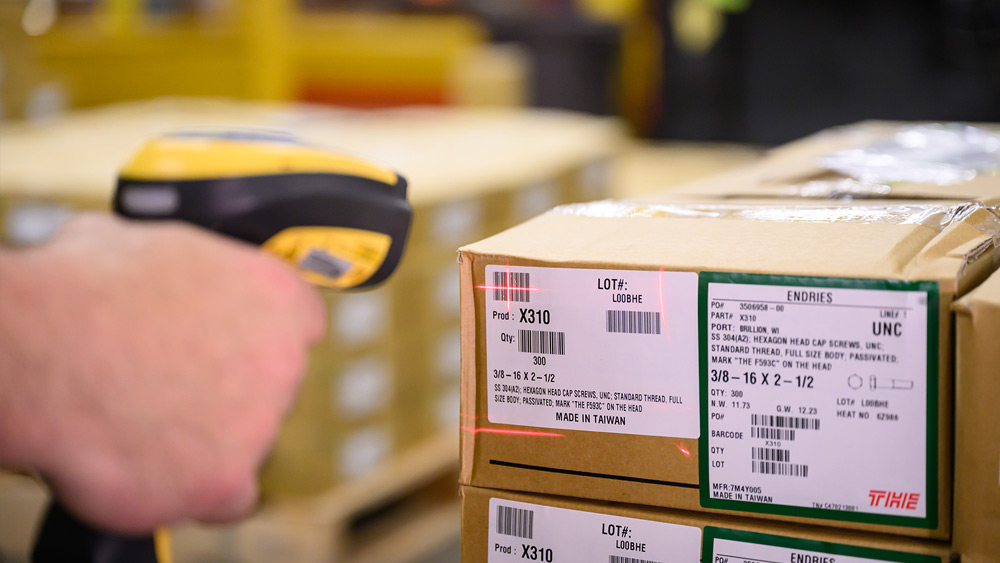 hand scanner targeting bar code on box