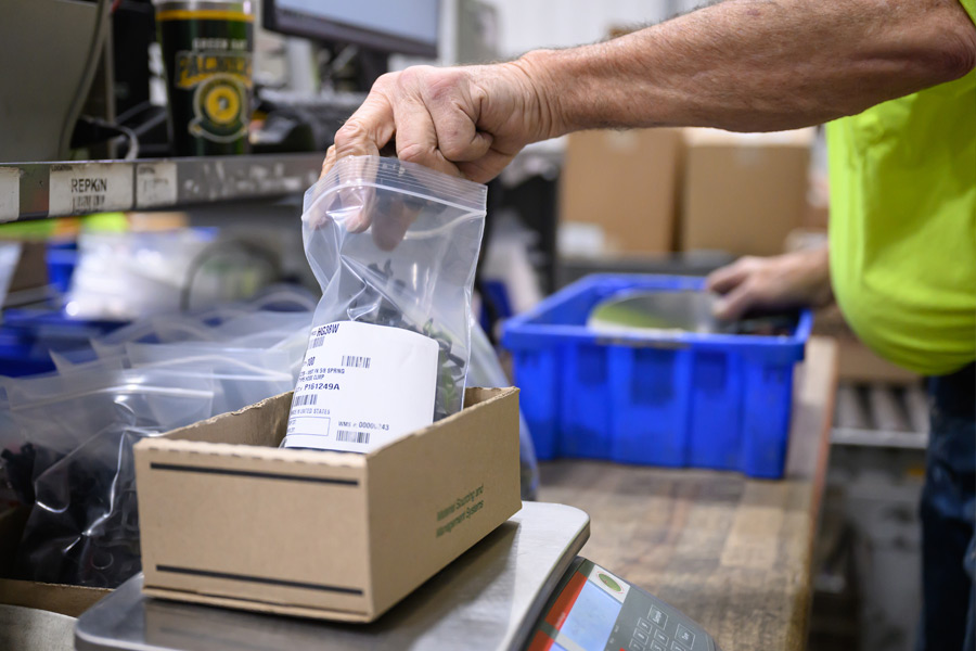 person packaging the completed kits